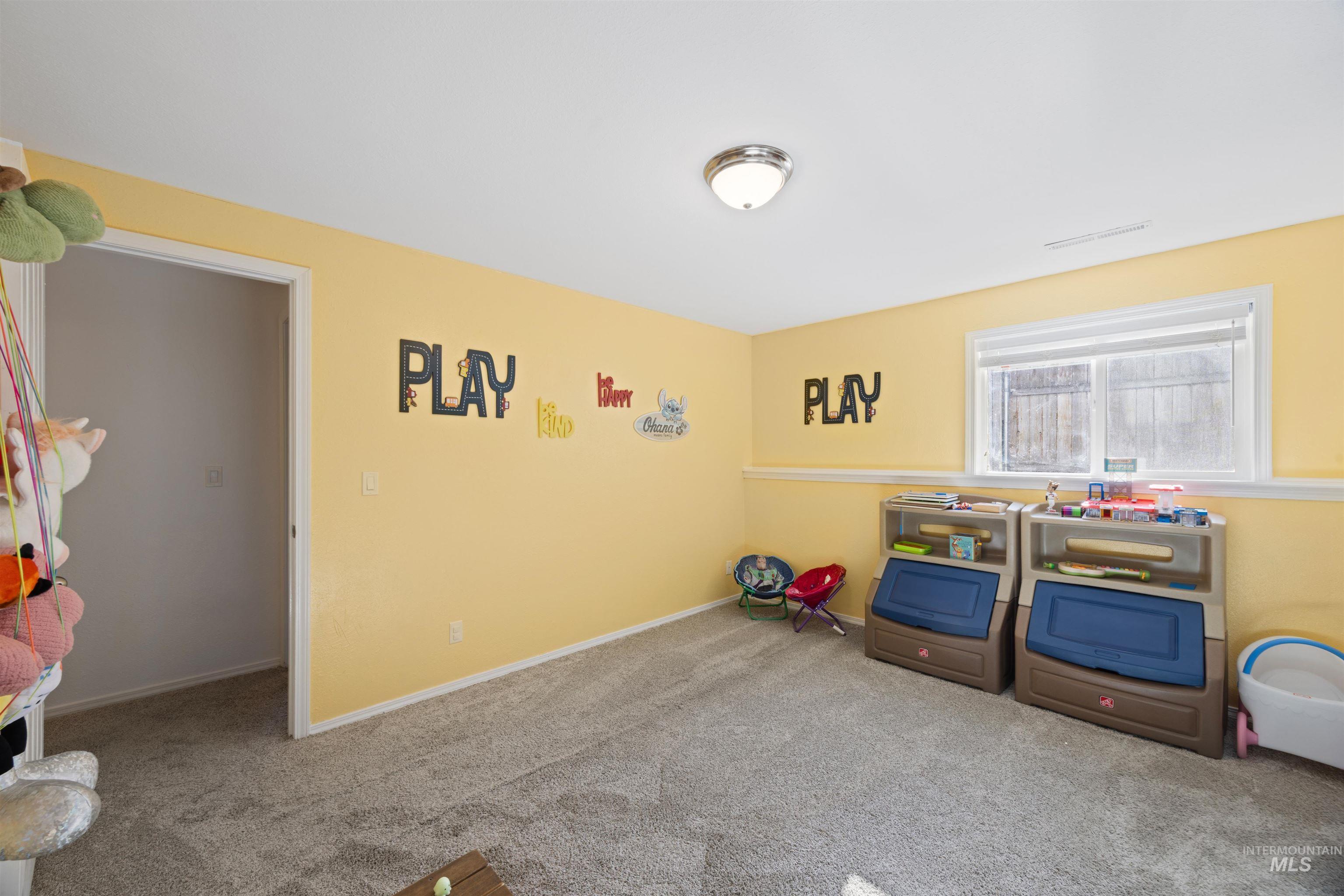 Rec room featuring carpet and baseboards