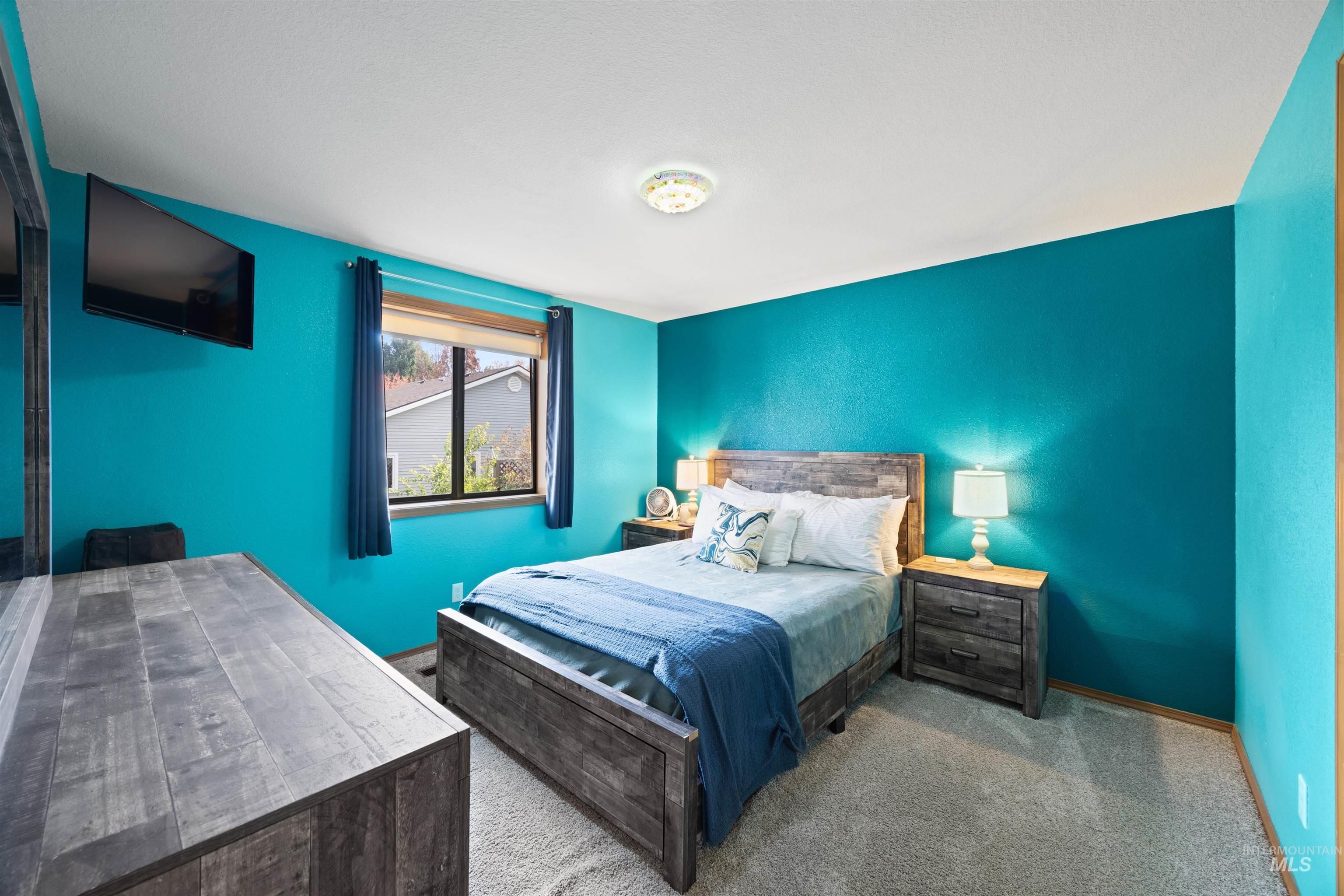 Bedroom featuring carpet floors and baseboards