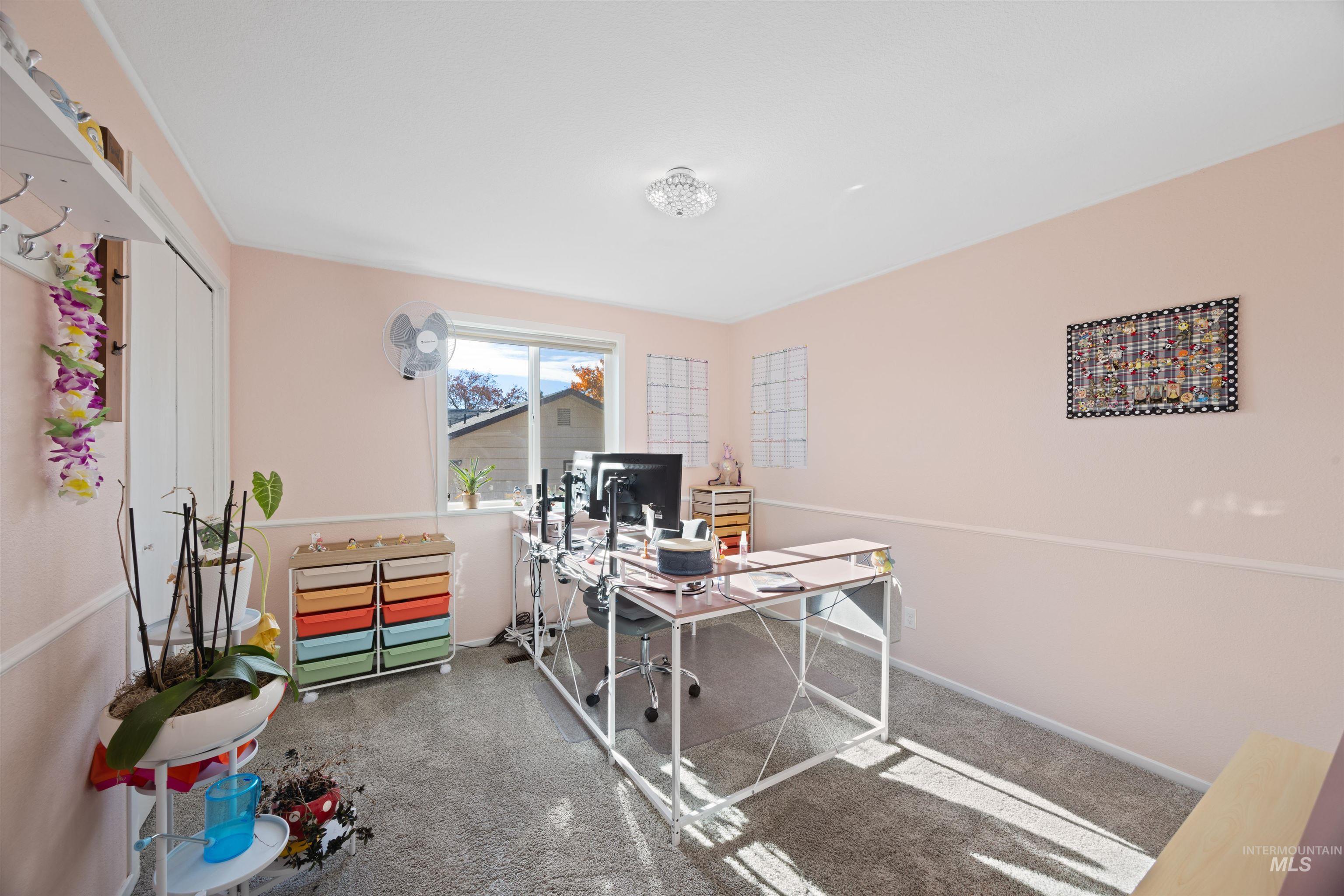 Carpeted office space with baseboards