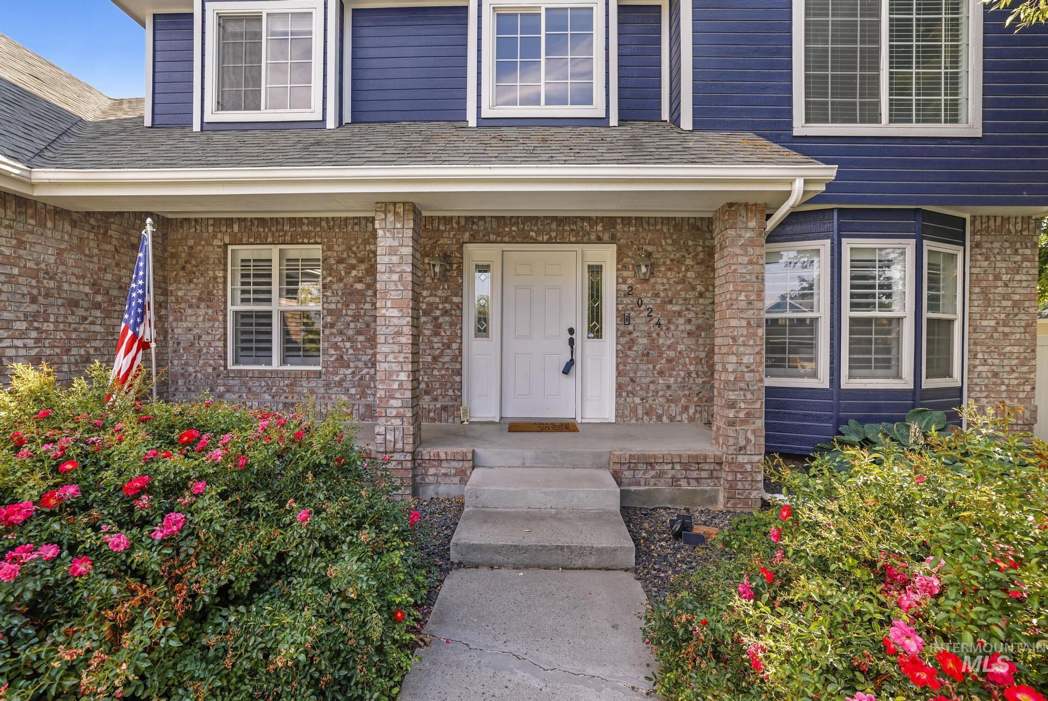 Property entrance featuring brick siding and covered porch