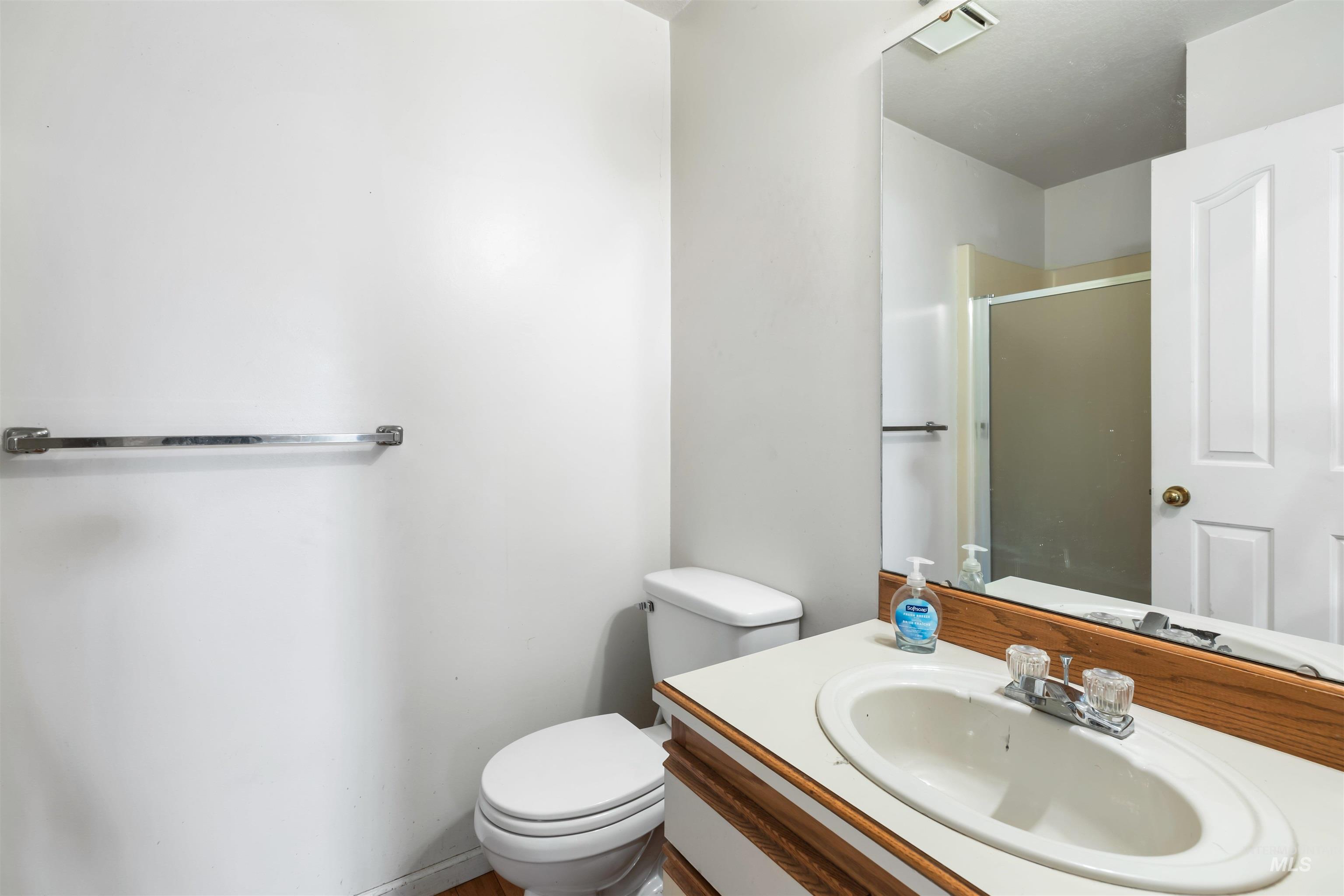 Full bath with a stall shower and vanity