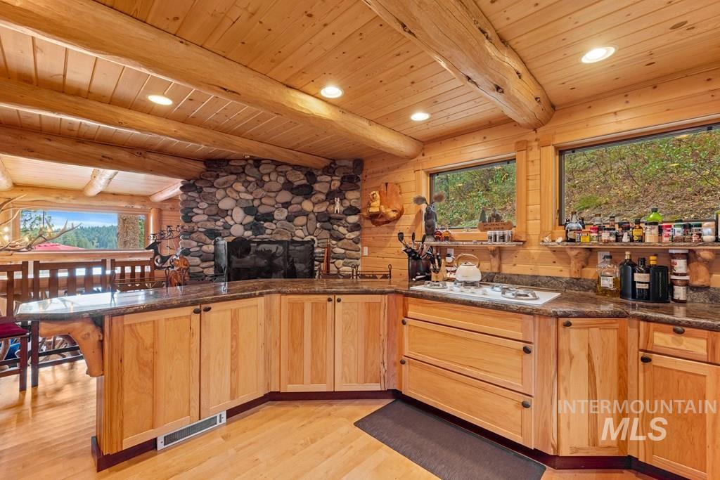 Kitchen featuring wood-paneled walls, wood-finish flooring, and recessed lighting