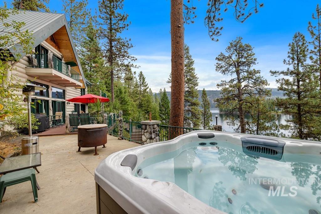 Outdoor hot tub with water feature situated on a concrete patio