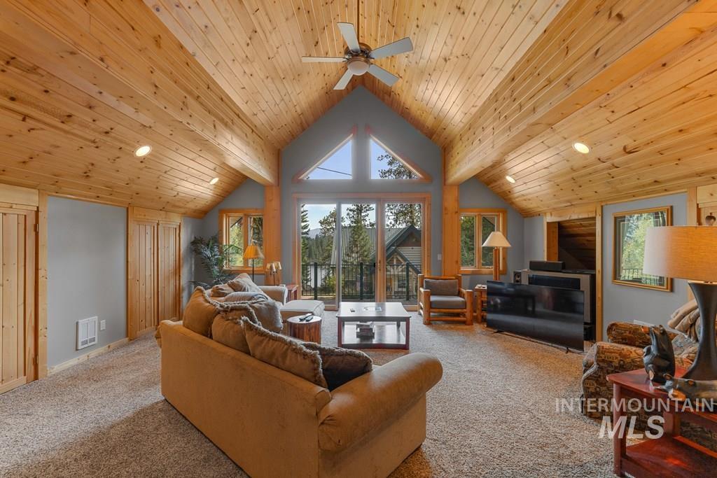 Vaulted wood-paneled ceiling with recessed lighting and a ceiling fan