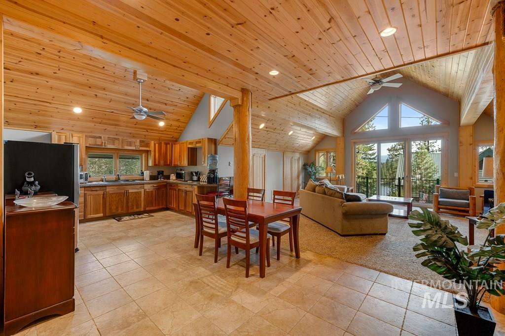 Open-concept living space featuring a vaulted wood-paneled ceiling, recessed lighting, and a ceiling fan