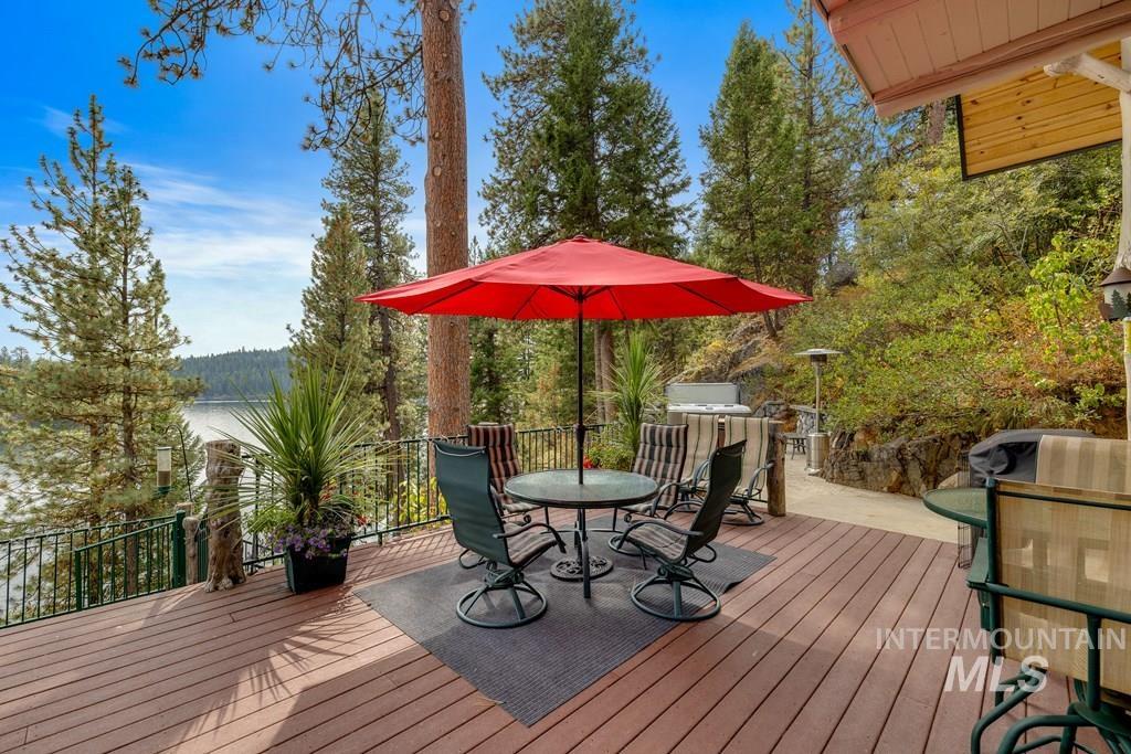 Expansive outdoor deck featuring wood-finish flooring and a metal railing