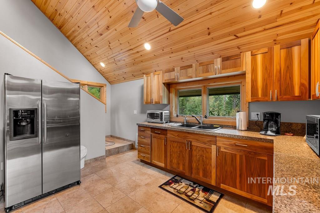 Kitchen featuring a vaulted wood-paneled ceiling, recessed lighting, and a ceiling fan
