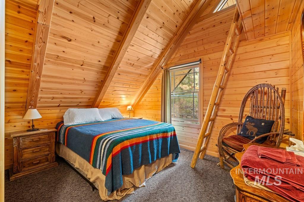 Pine wood-paneled walls and ceiling with exposed beams