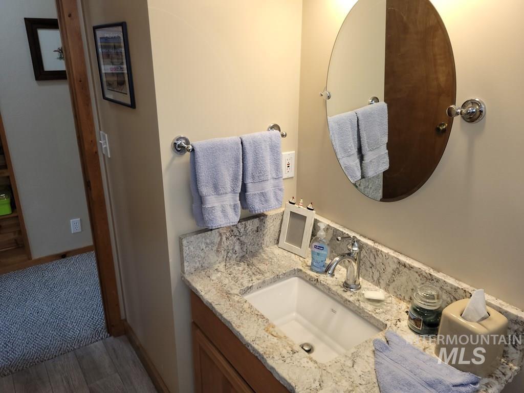 Bathroom with vanity and dark wood-style floors
