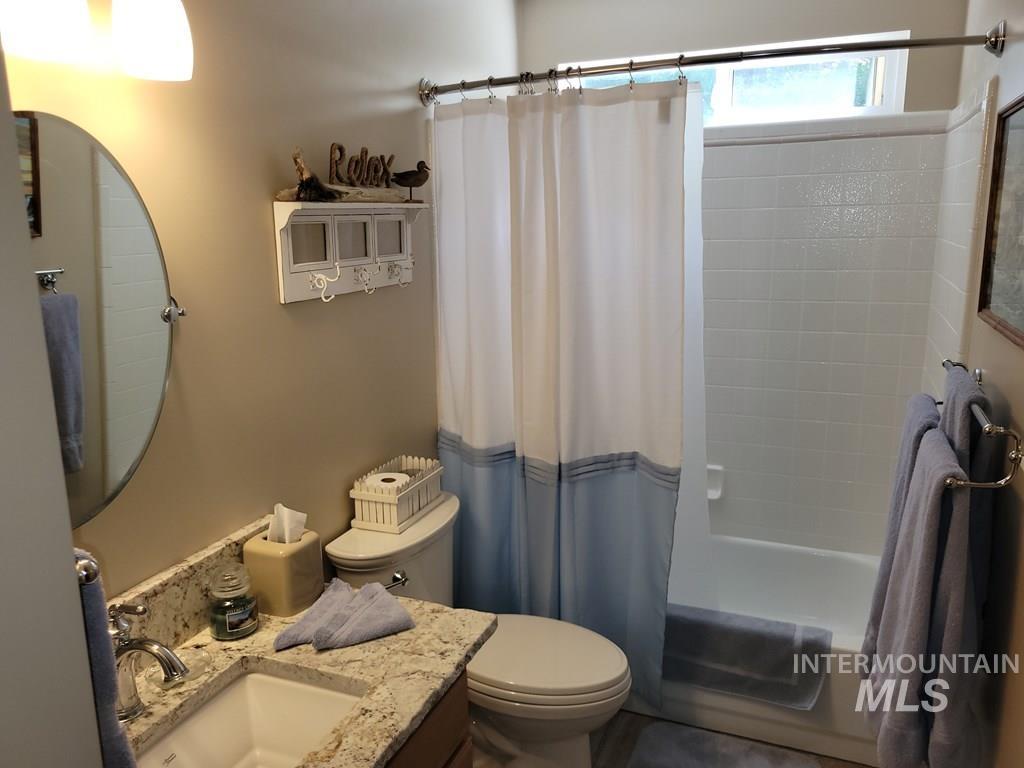 Full bath featuring shower / tub combo and vanity