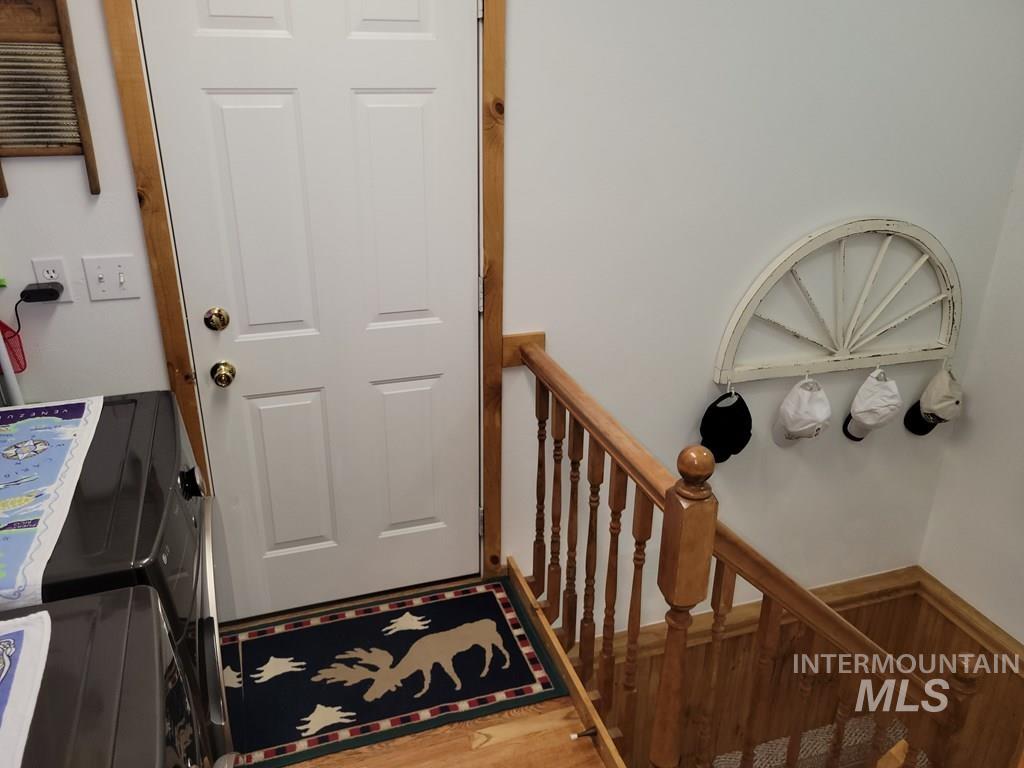 Stairs with wood finished floors and wainscoting