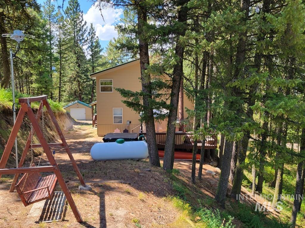 View of playground with an outdoor structure and a wooden deck