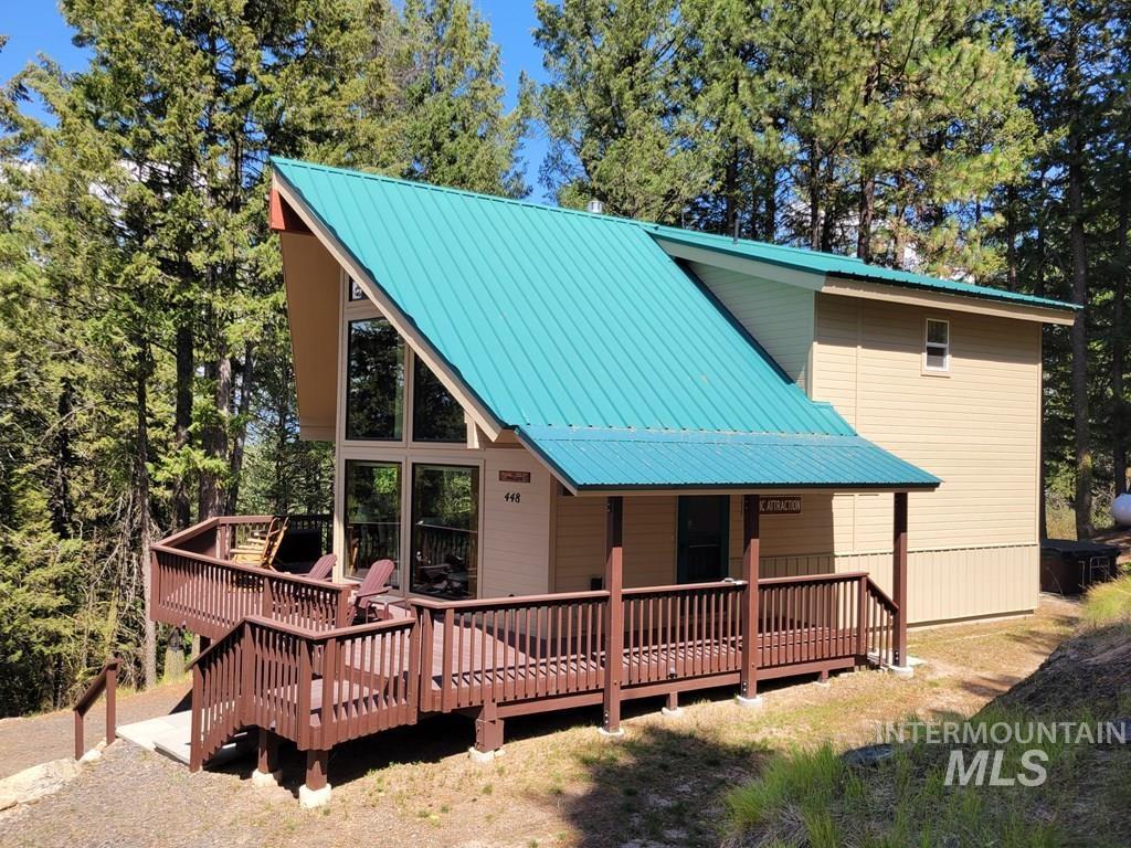 View of front of home featuring a deck and a metal roof