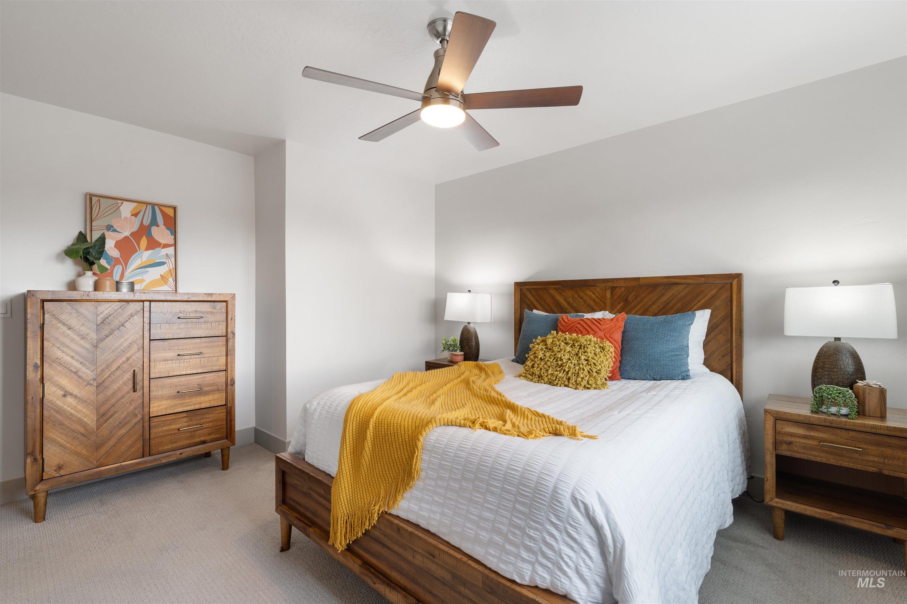 Bedroom featuring a ceiling fan with integrated lighting, recessed lighting, and light-toned carpeting