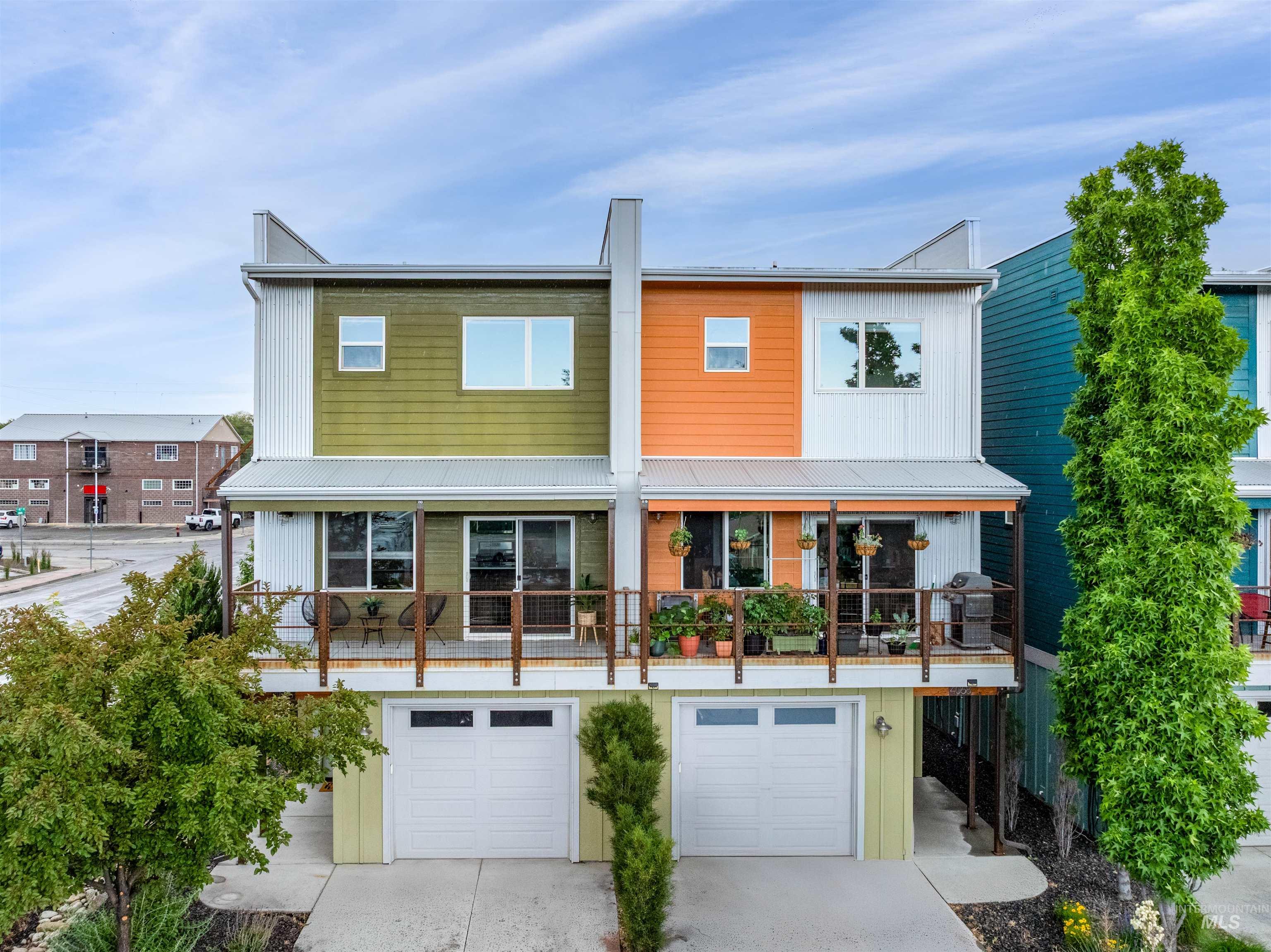 Modern-style townhome with distinctive colorful siding and a metal roof