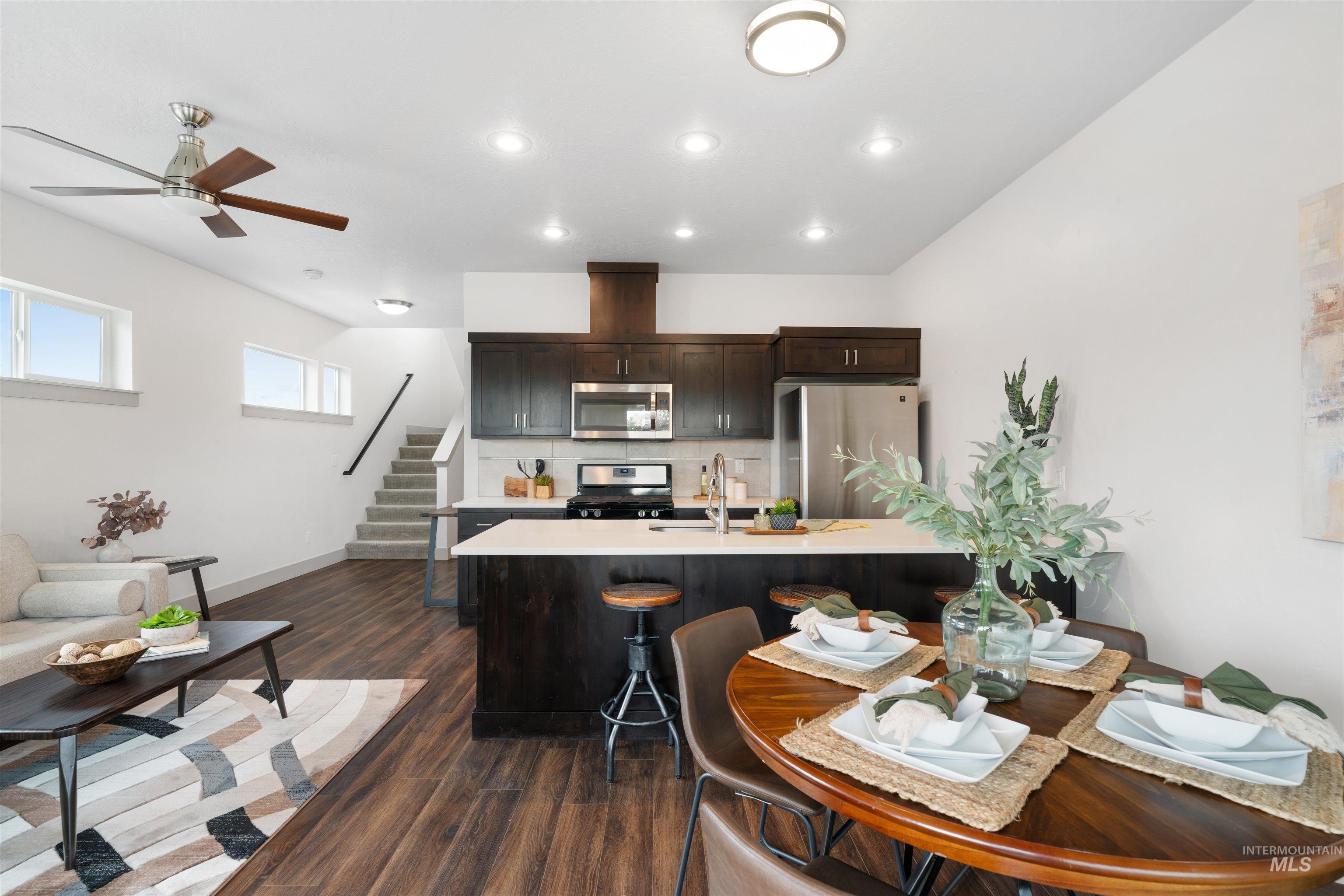 Open concept living area featuring dark wood-finish flooring, recessed lighting, and a contemporary ceiling fan