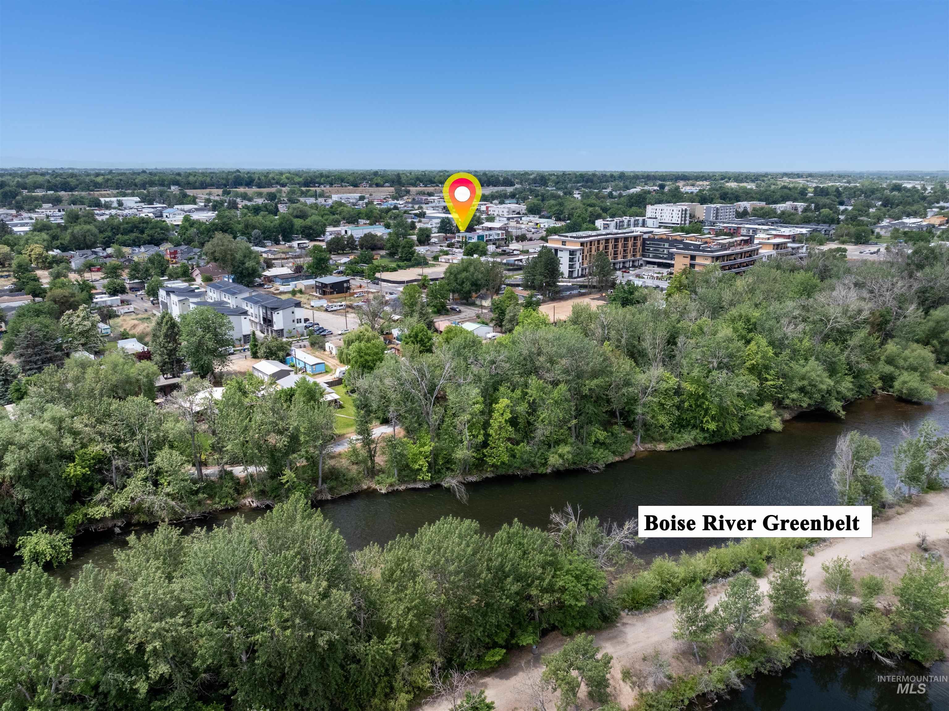 Aerial perspective showcasing the Boise River Greenbelt alongside surrounding urban development