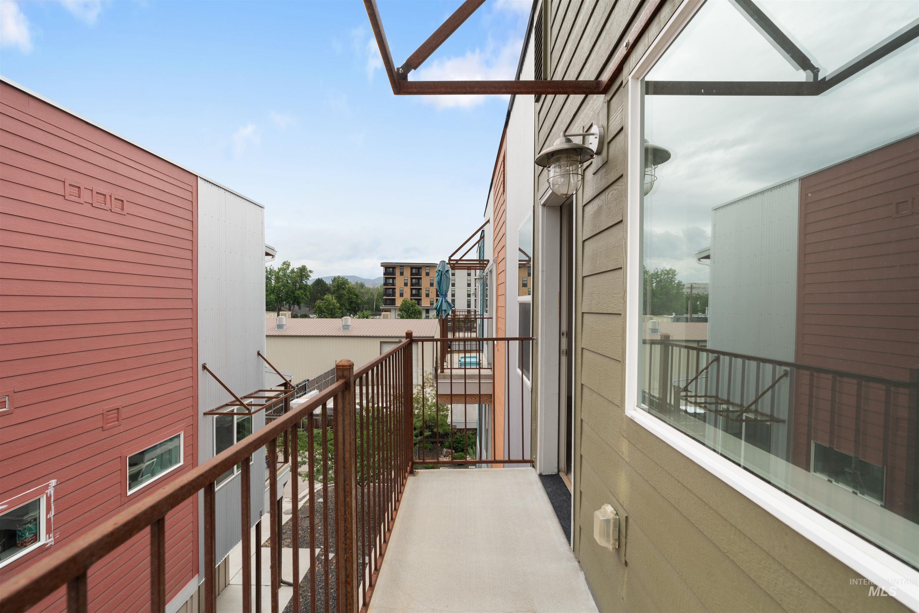Private balcony featuring concrete flooring and metal railings