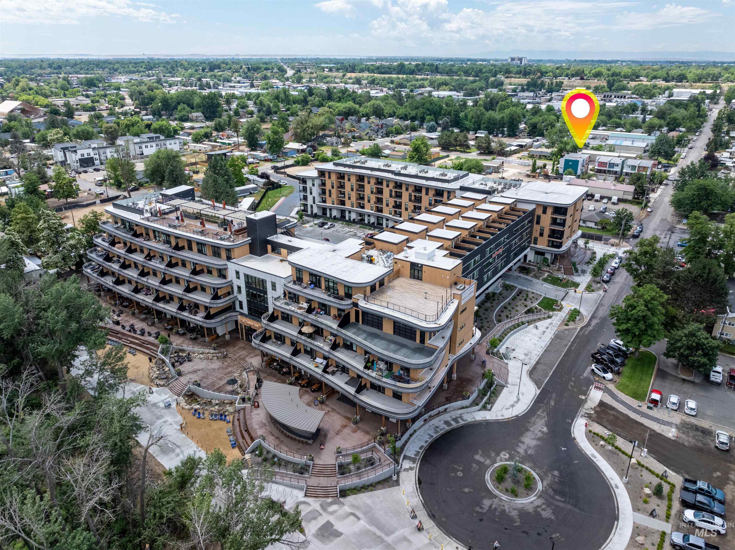 Modern multi-story building featuring extensive private balconies and rooftop access