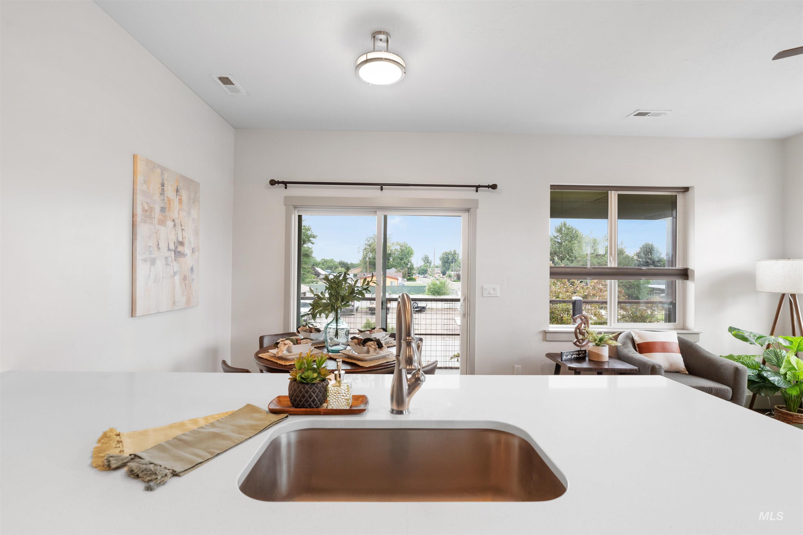 Kitchen island featuring a single-basin sink with a gooseneck faucet