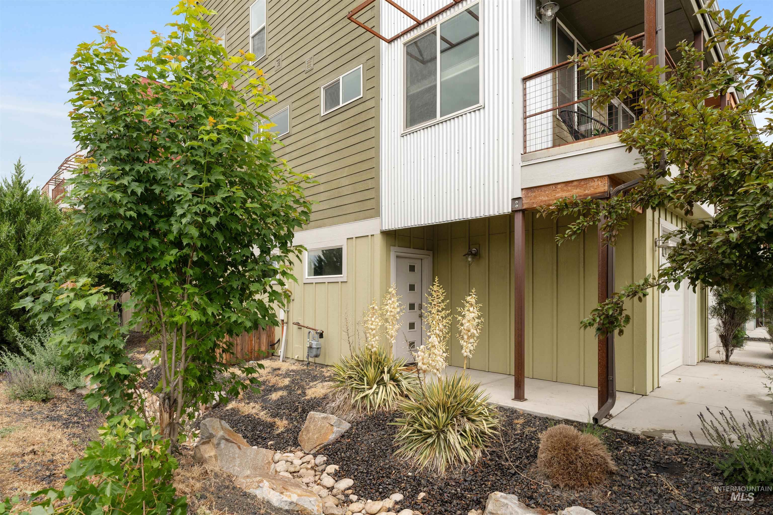 Modern architectural styling featuring a vertical board and batten facade and corrugated metal accents