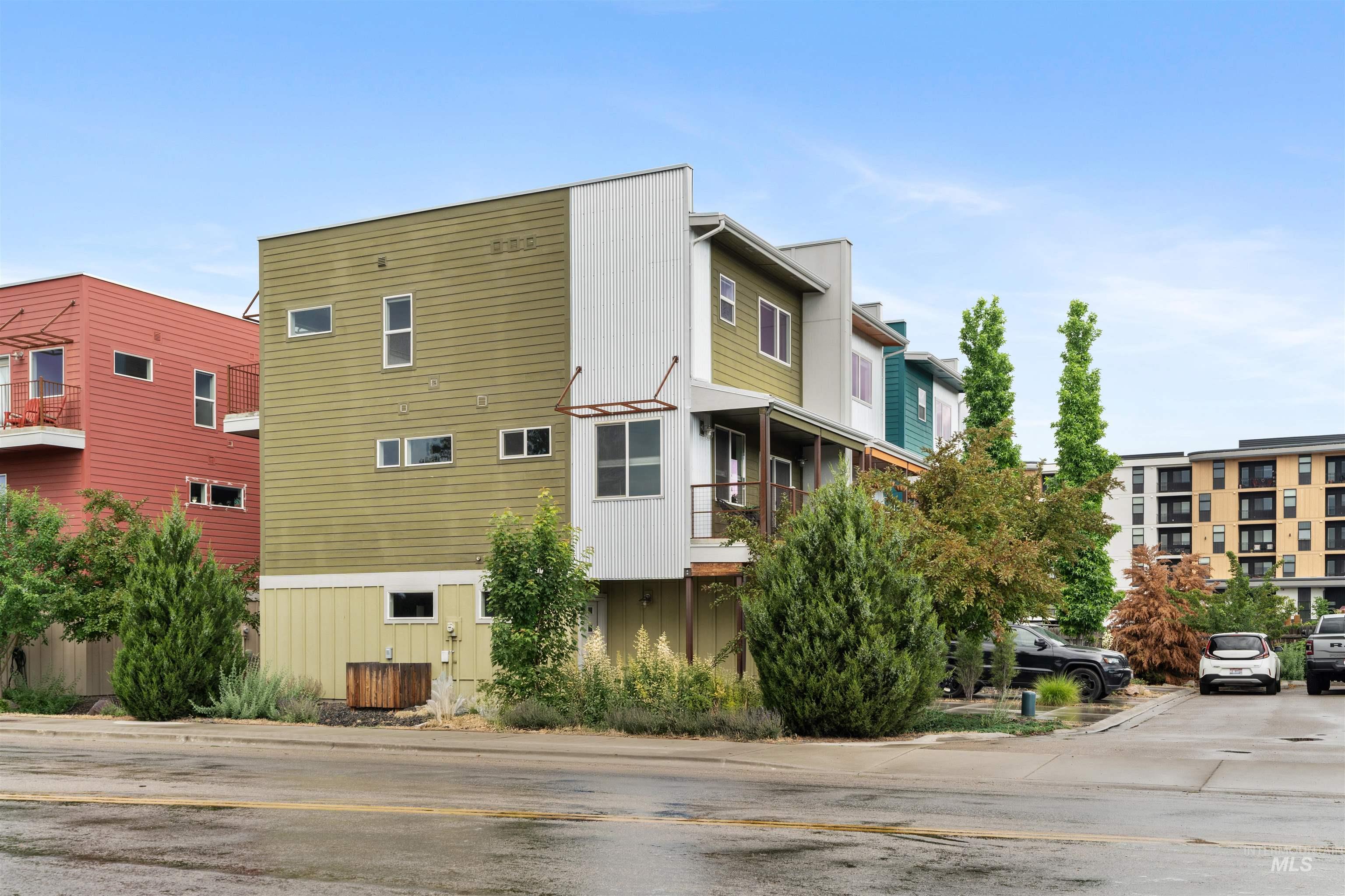 Contemporary townhome with multi-color siding and numerous windows