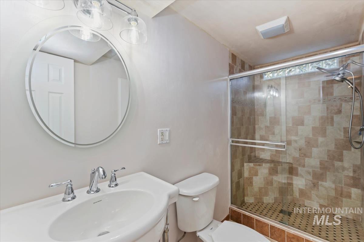 Full bathroom featuring a stall shower and vanity