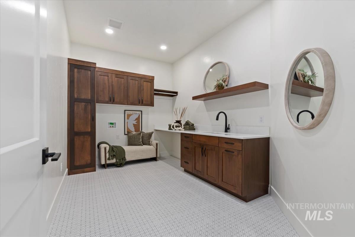 Laundry room with recessed lighting and light colored carpet