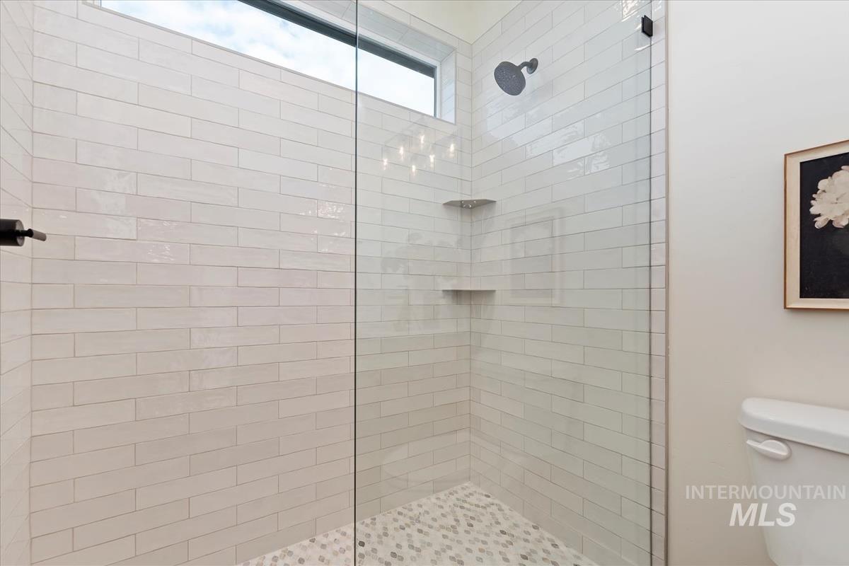 Bathroom featuring walk in shower and toilet