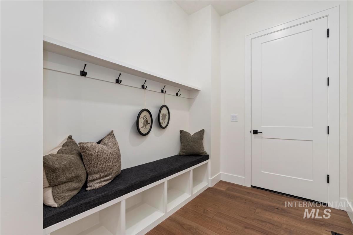 Mudroom with dark wood-style flooring and baseboards