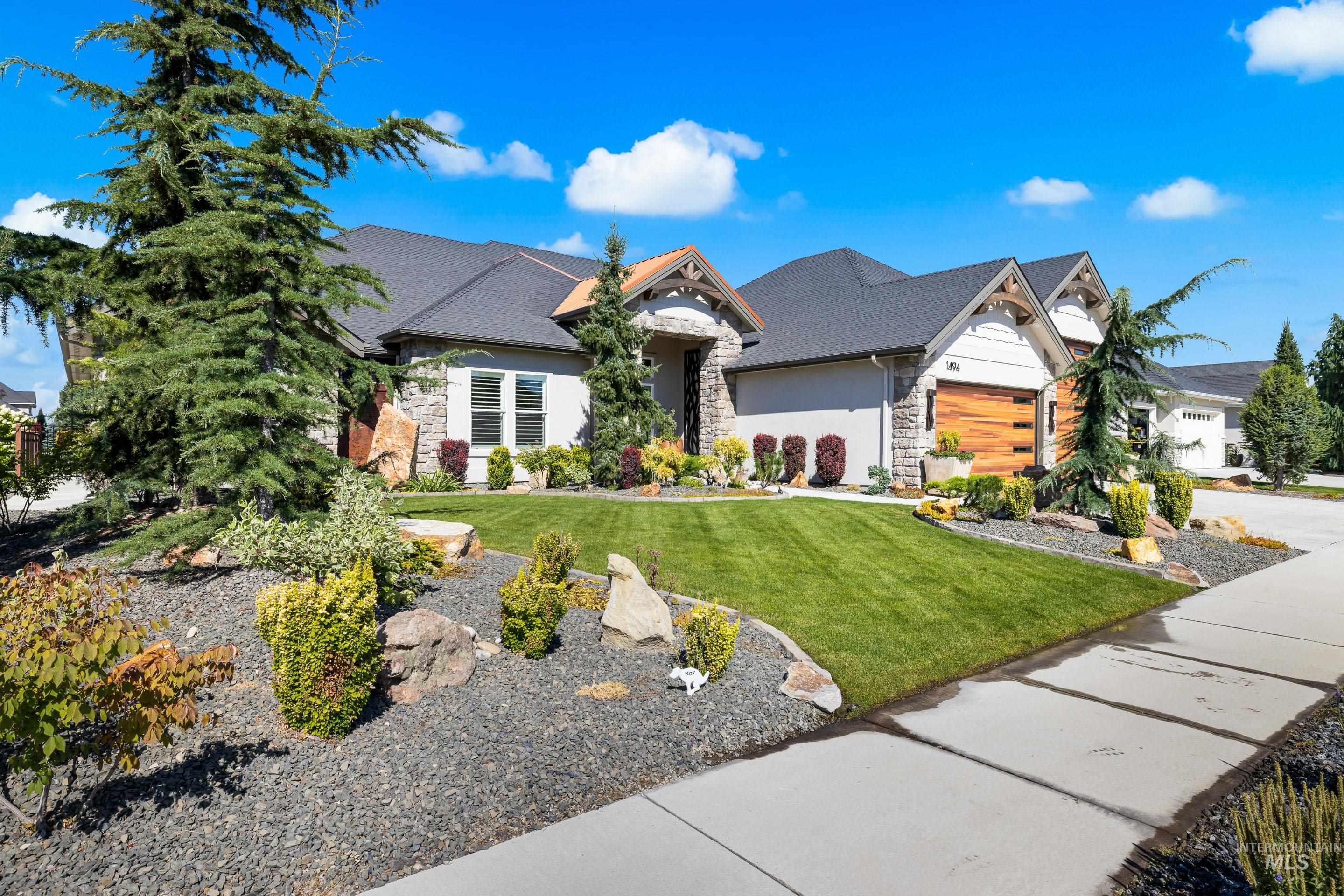 Craftsman inspired home with stone siding, a front lawn, stucco siding, a garage, and concrete driveway