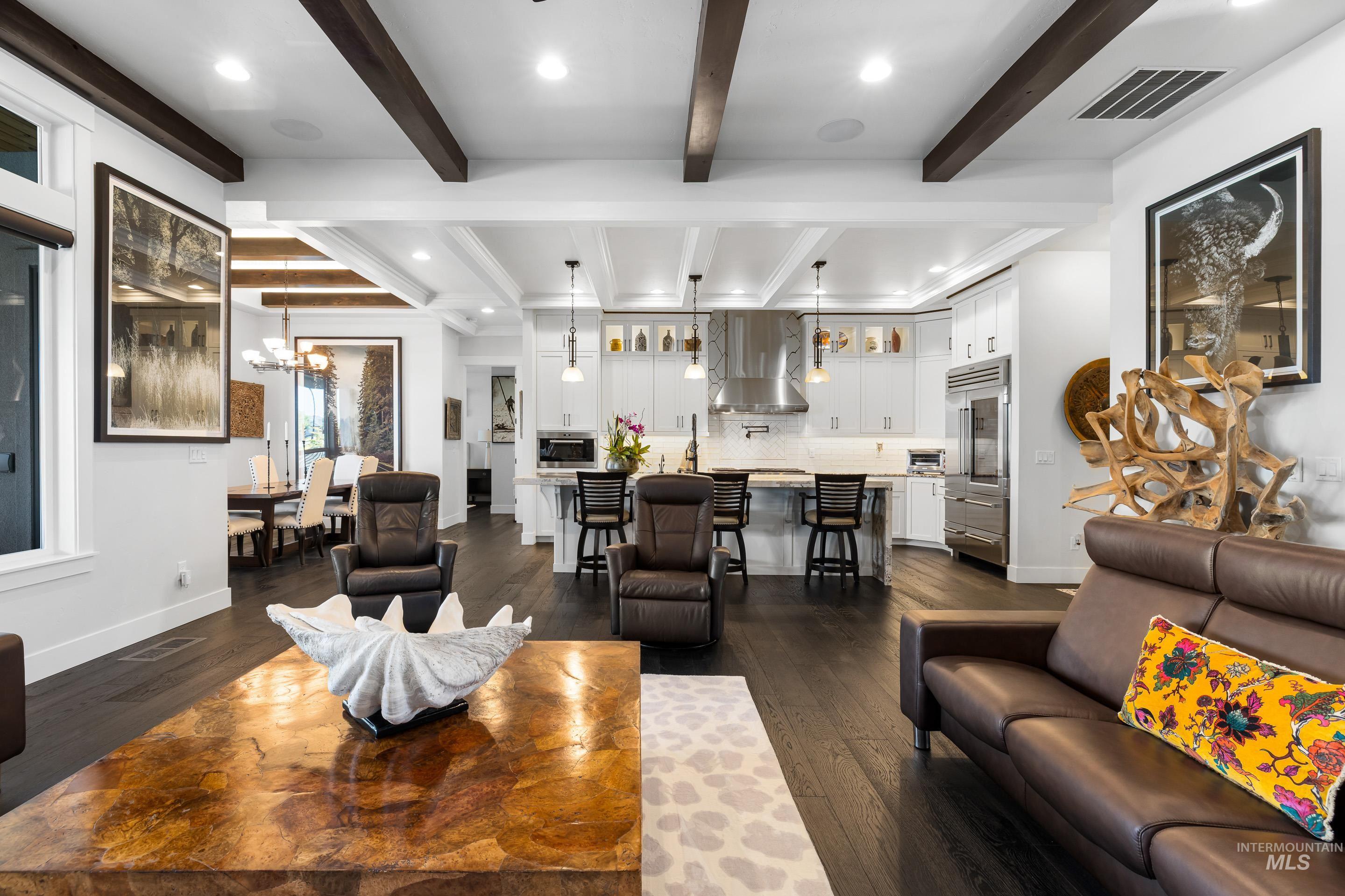 Living area featuring recessed lighting, dark wood finished floors, beam ceiling, and a chandelier
