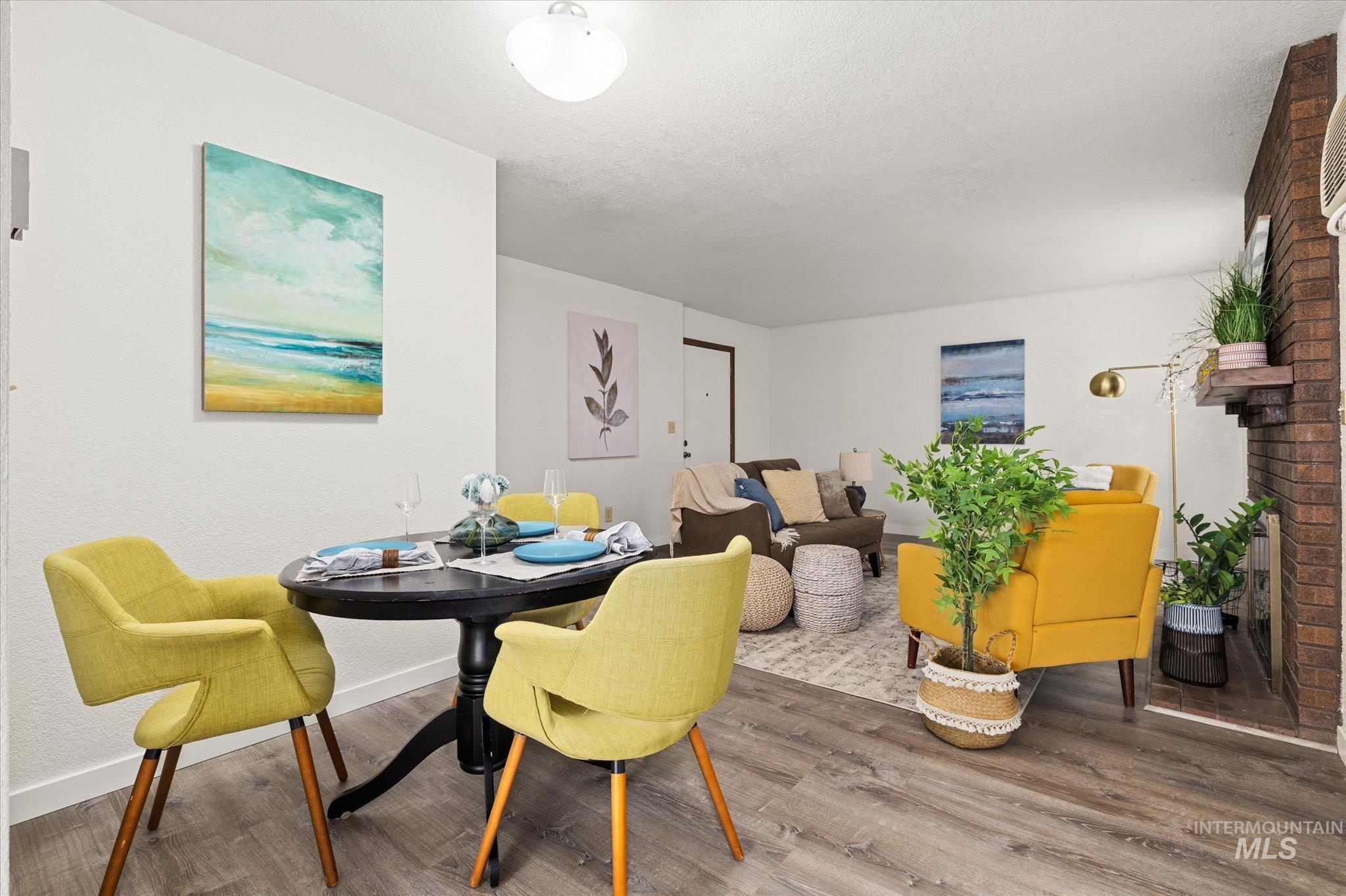 Dining room featuring a fireplace and wood finished floors