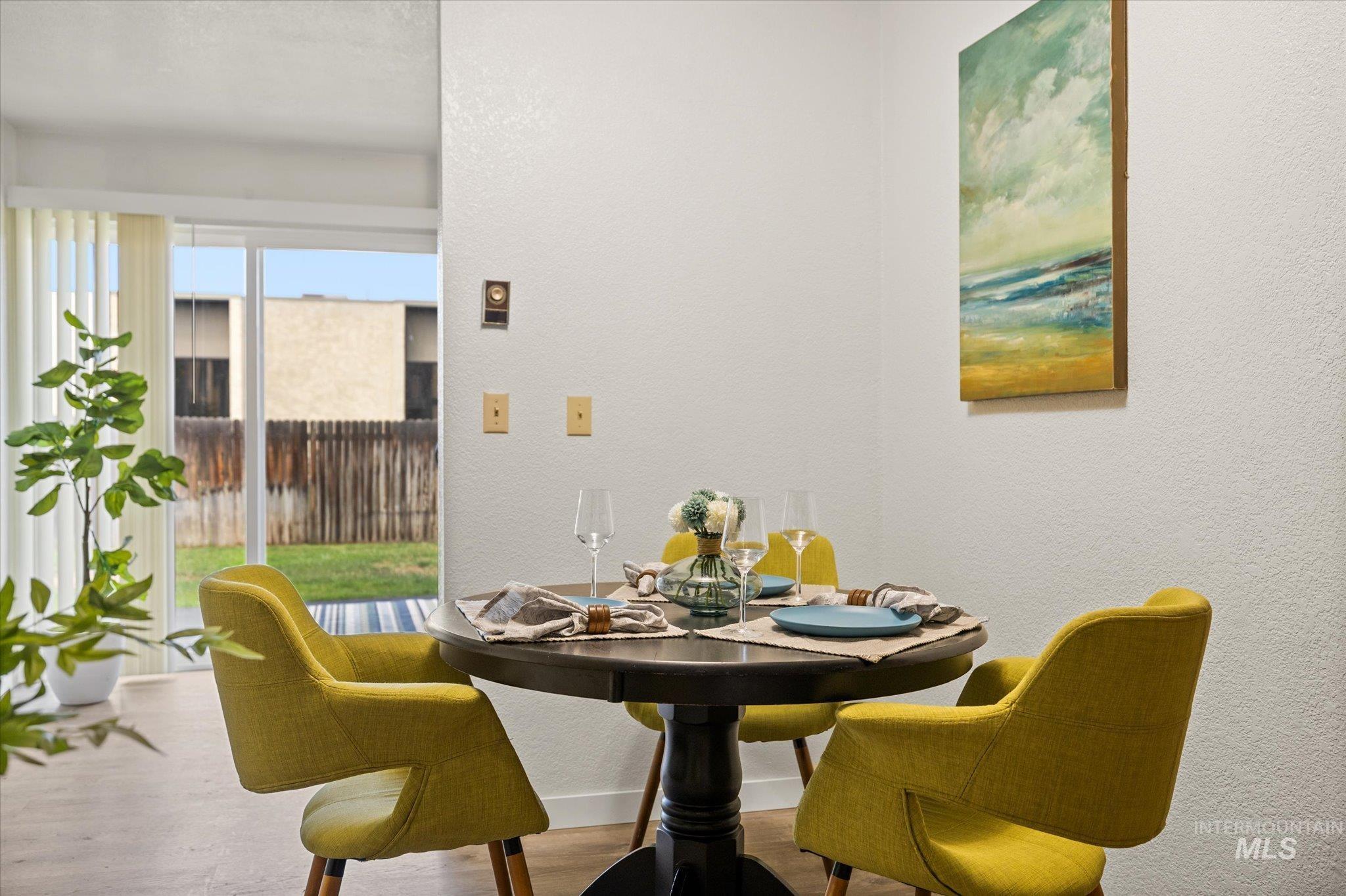 Dining room featuring a textured wall and wood finished floors