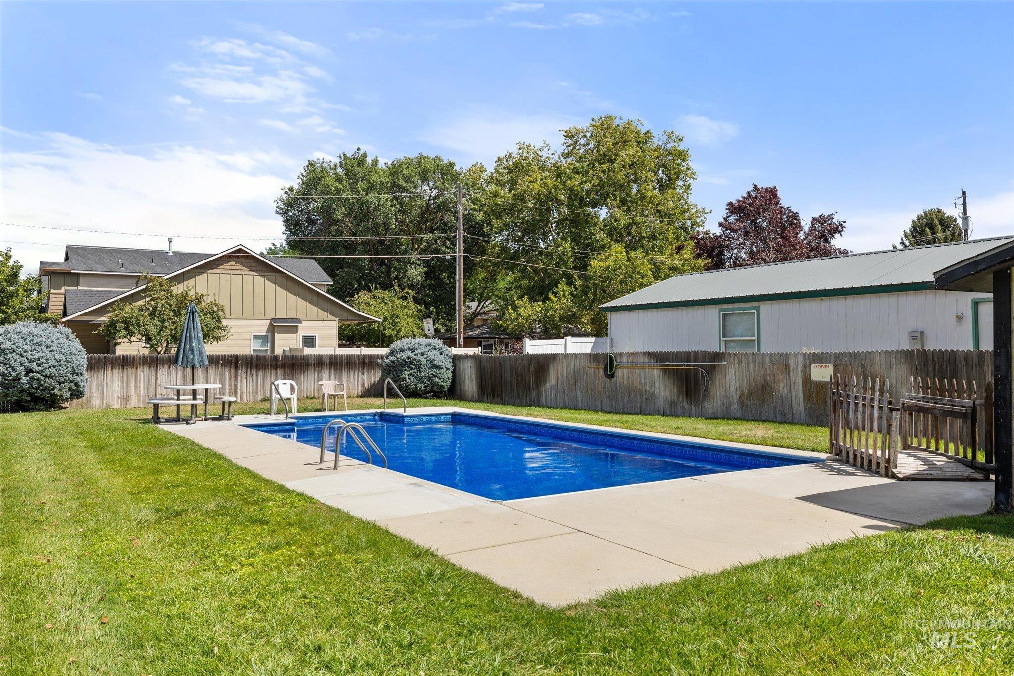 View of swimming pool featuring a fenced backyard and a patio area