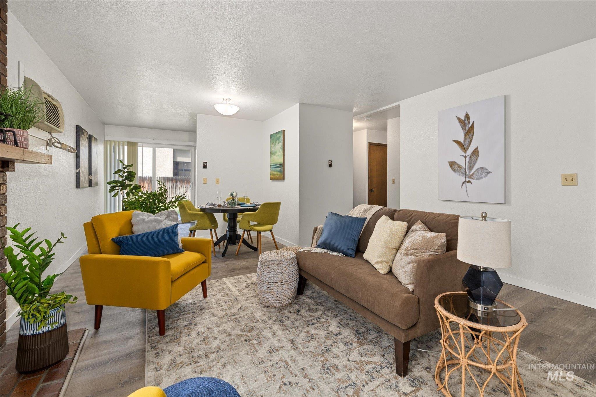 Living area with wood finished floors and a textured ceiling