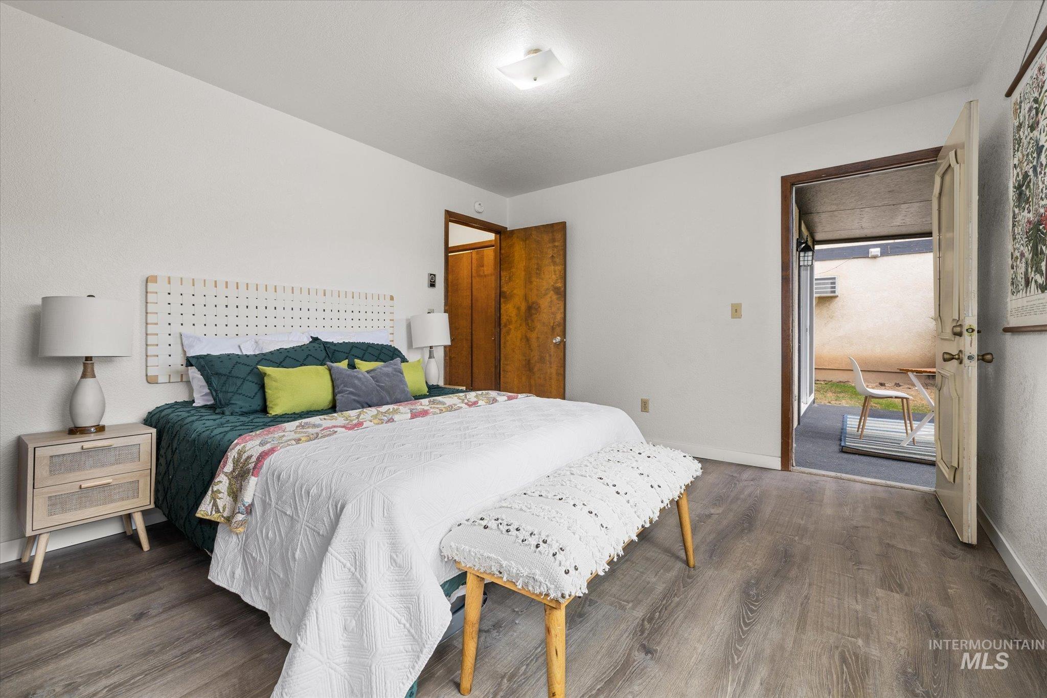 Bedroom featuring dark wood-type flooring and access to exterior