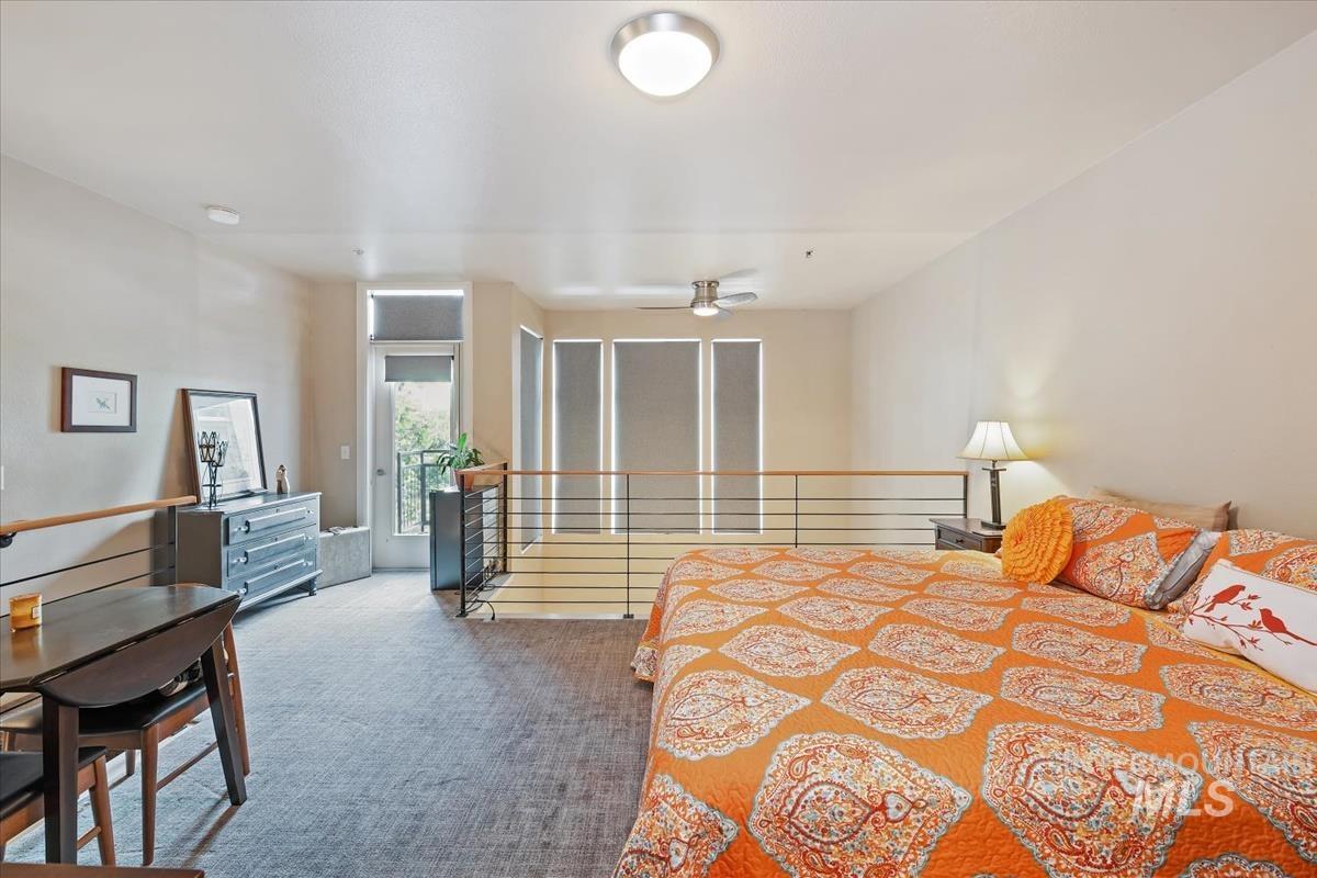 Bedroom with access to outside and carpet