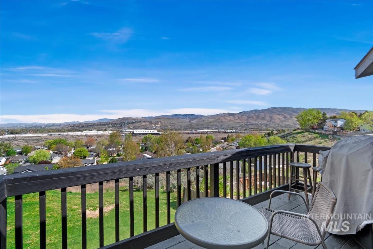 Balcony featuring grilling area and a mountain view
