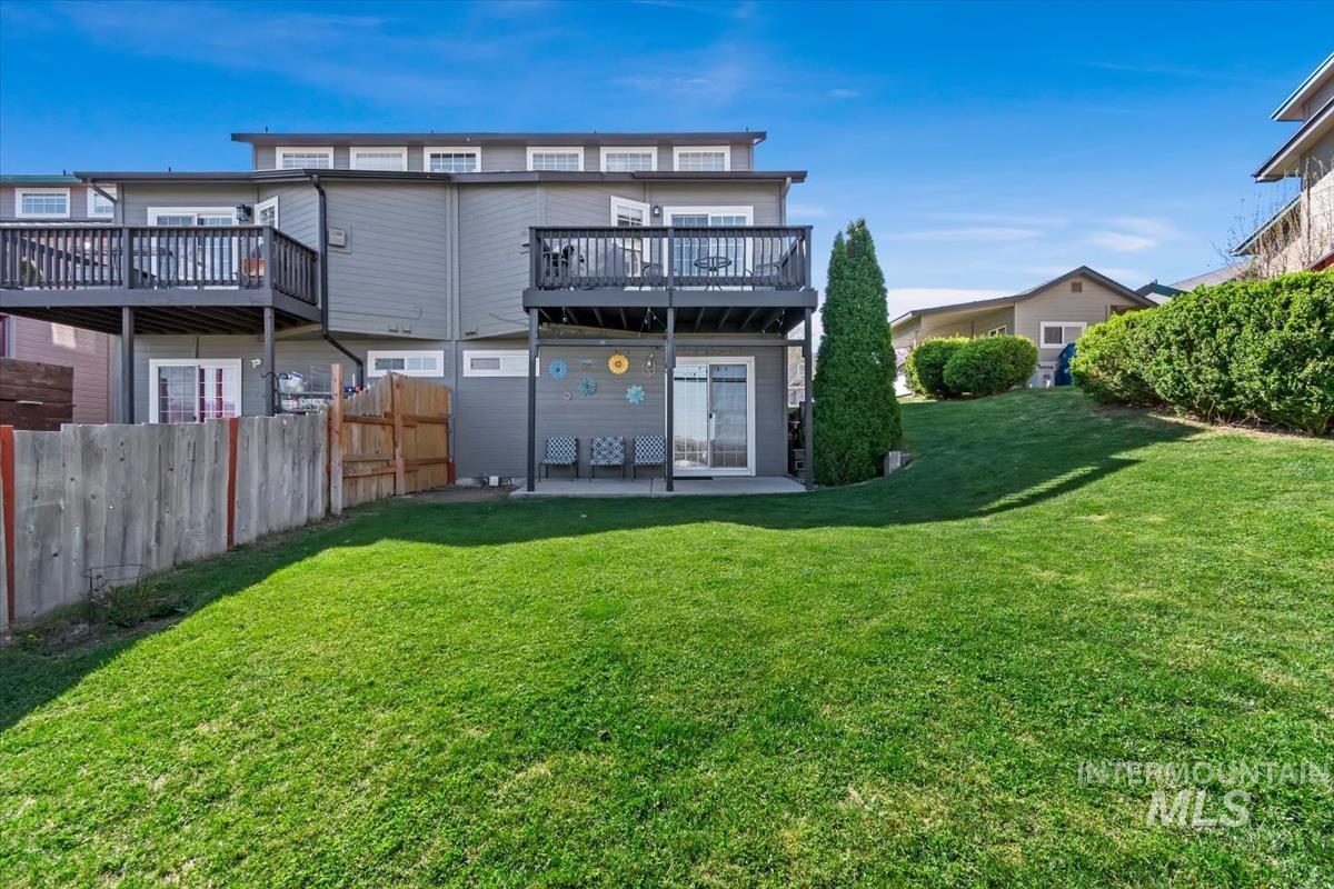 Back of property with a patio area and a wooden deck