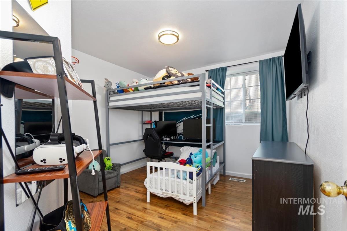 Bedroom featuring light wood-style floors and an office area