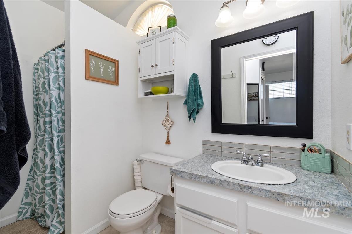 Full bathroom featuring vanity and curtained shower