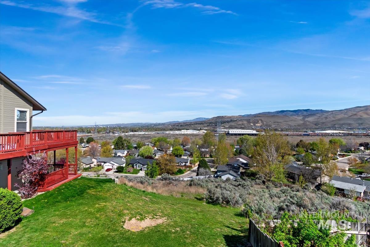 View of grassy yard featuring a residential view and a mountain view