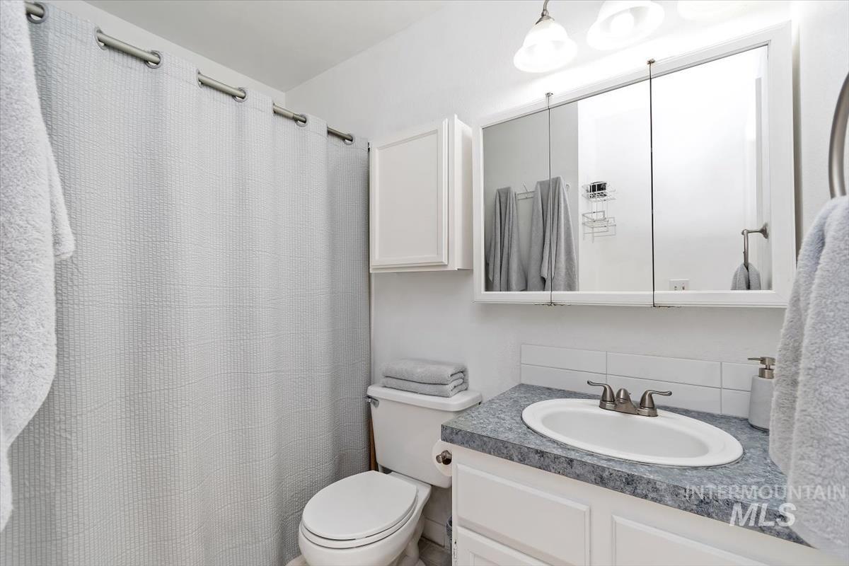 Full bathroom featuring vanity and a shower with curtain