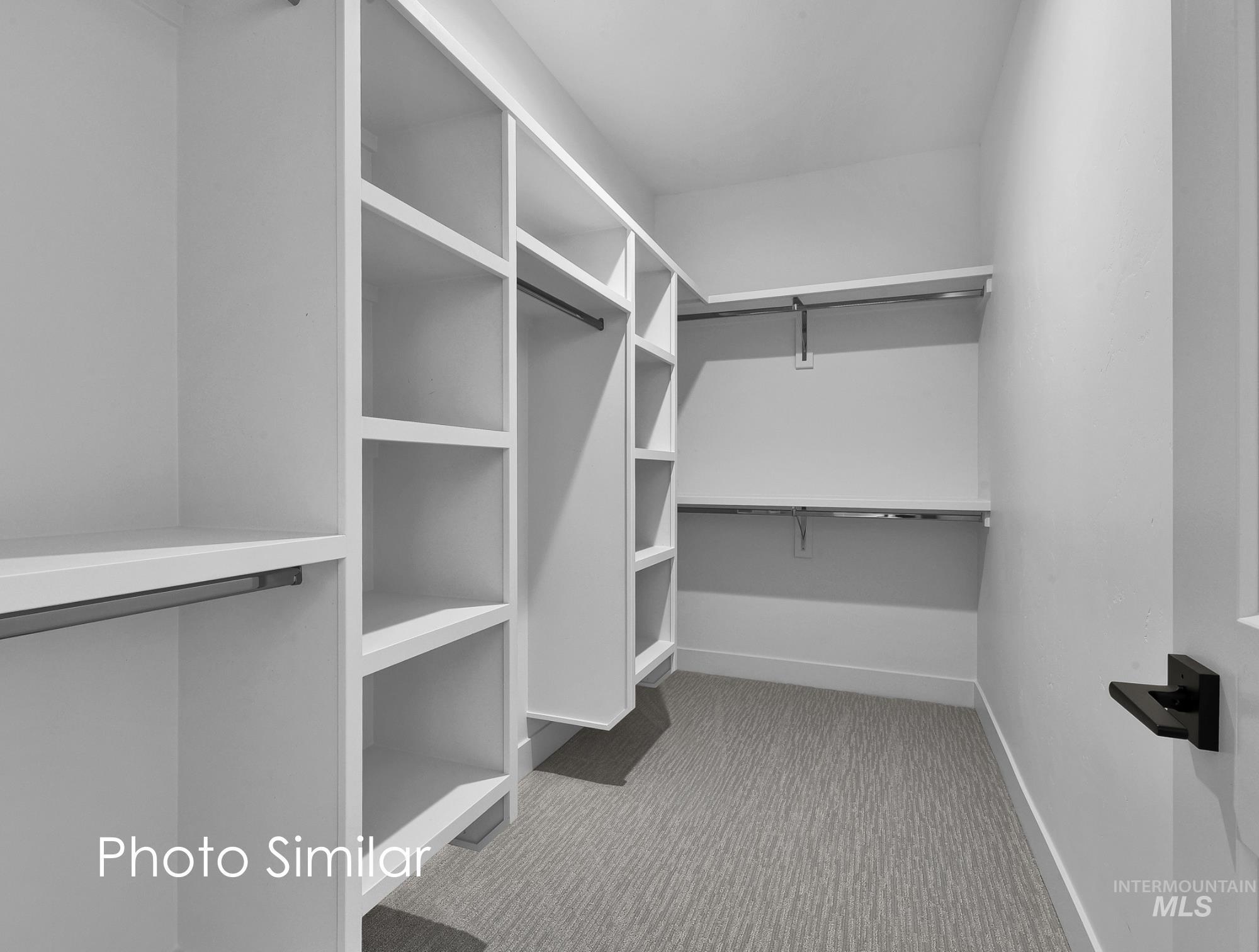 Custom closet system featuring white shelving and hanging rods