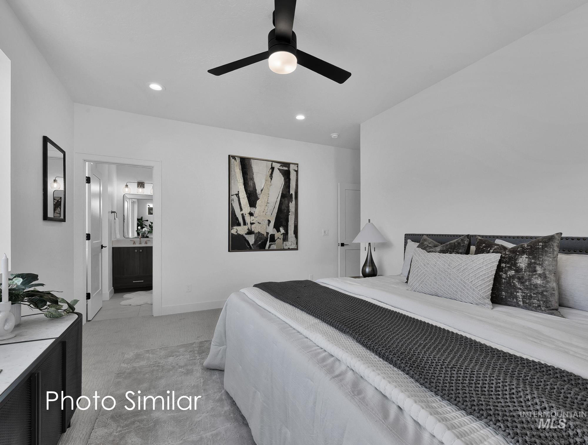 Spacious bedroom featuring plush carpeting, a contemporary black ceiling fan with integrated lighting, and recessed lighting