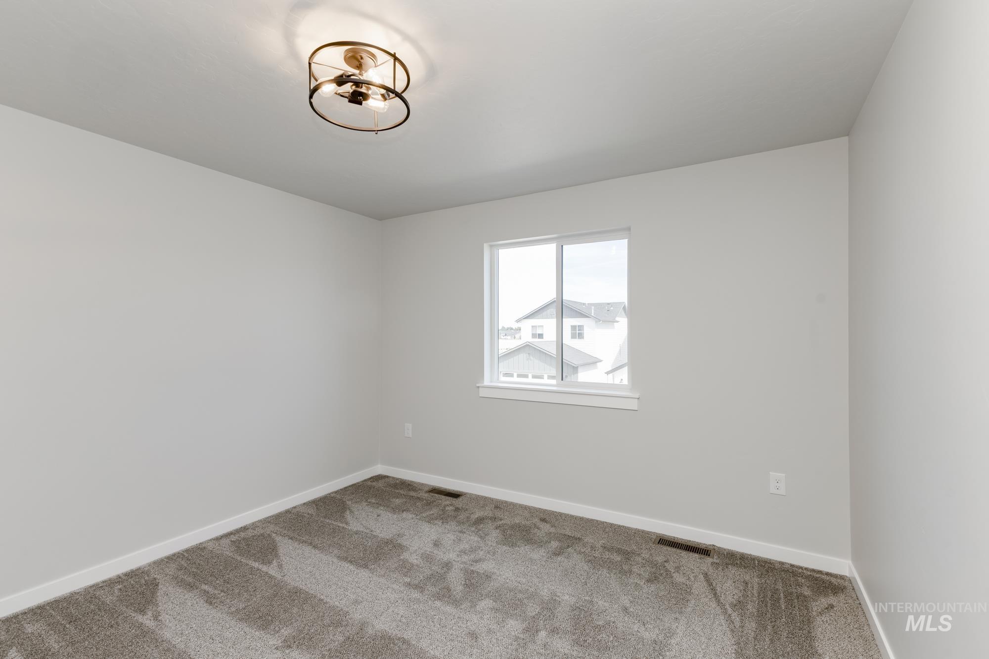 Carpeted empty room with baseboards