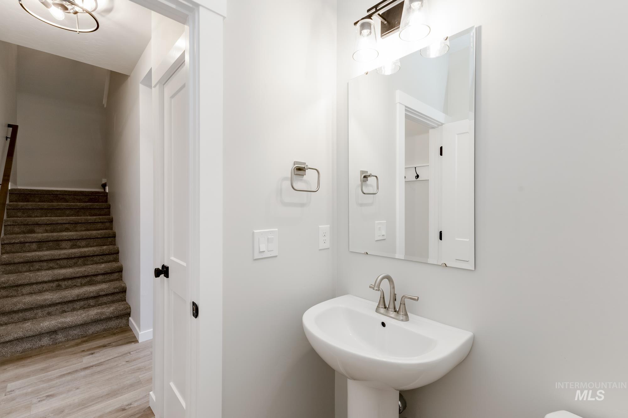 Bathroom with light wood-style flooring and baseboards