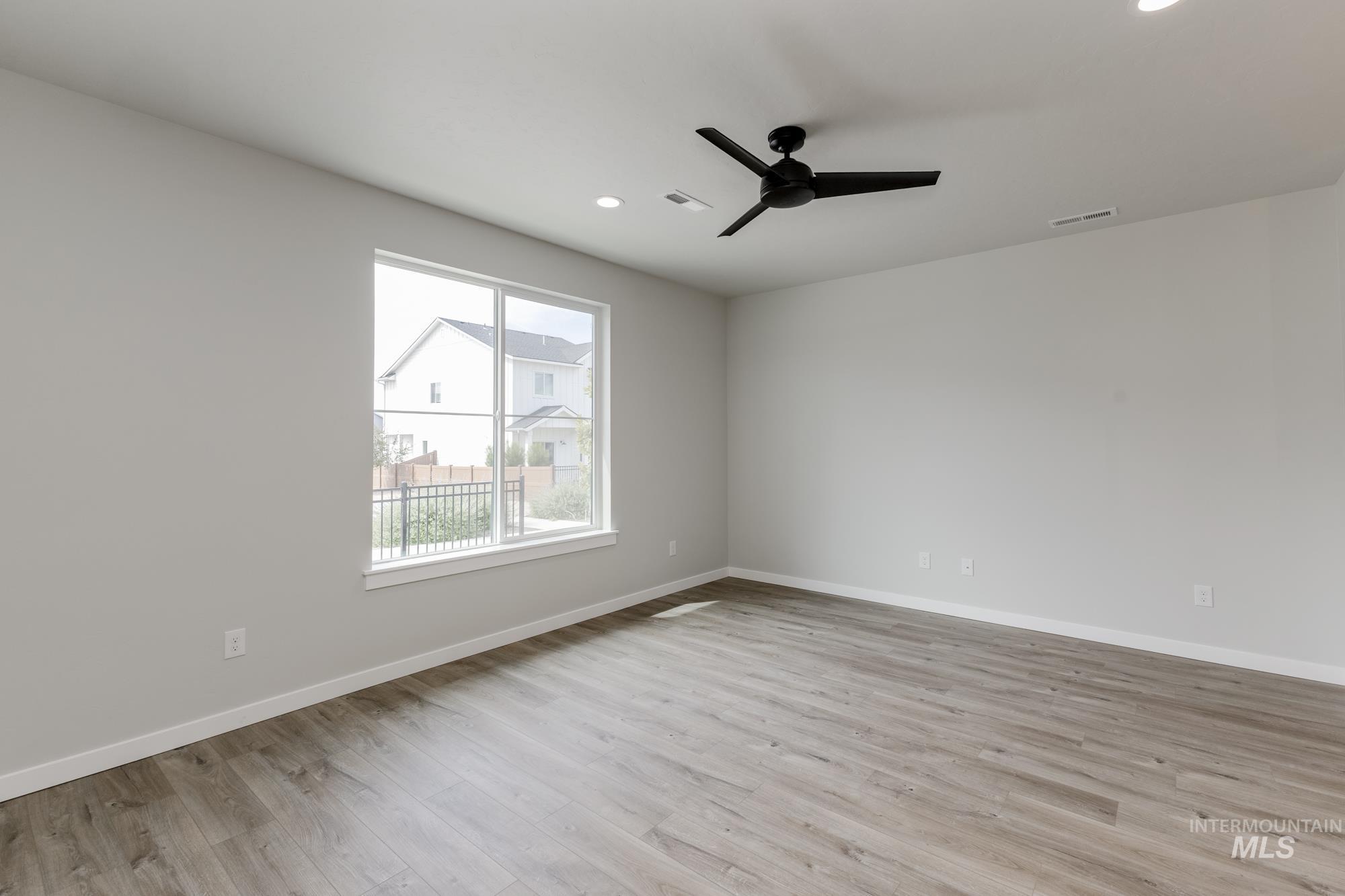 Empty room featuring light wood finished floors, recessed lighting, and ceiling fan