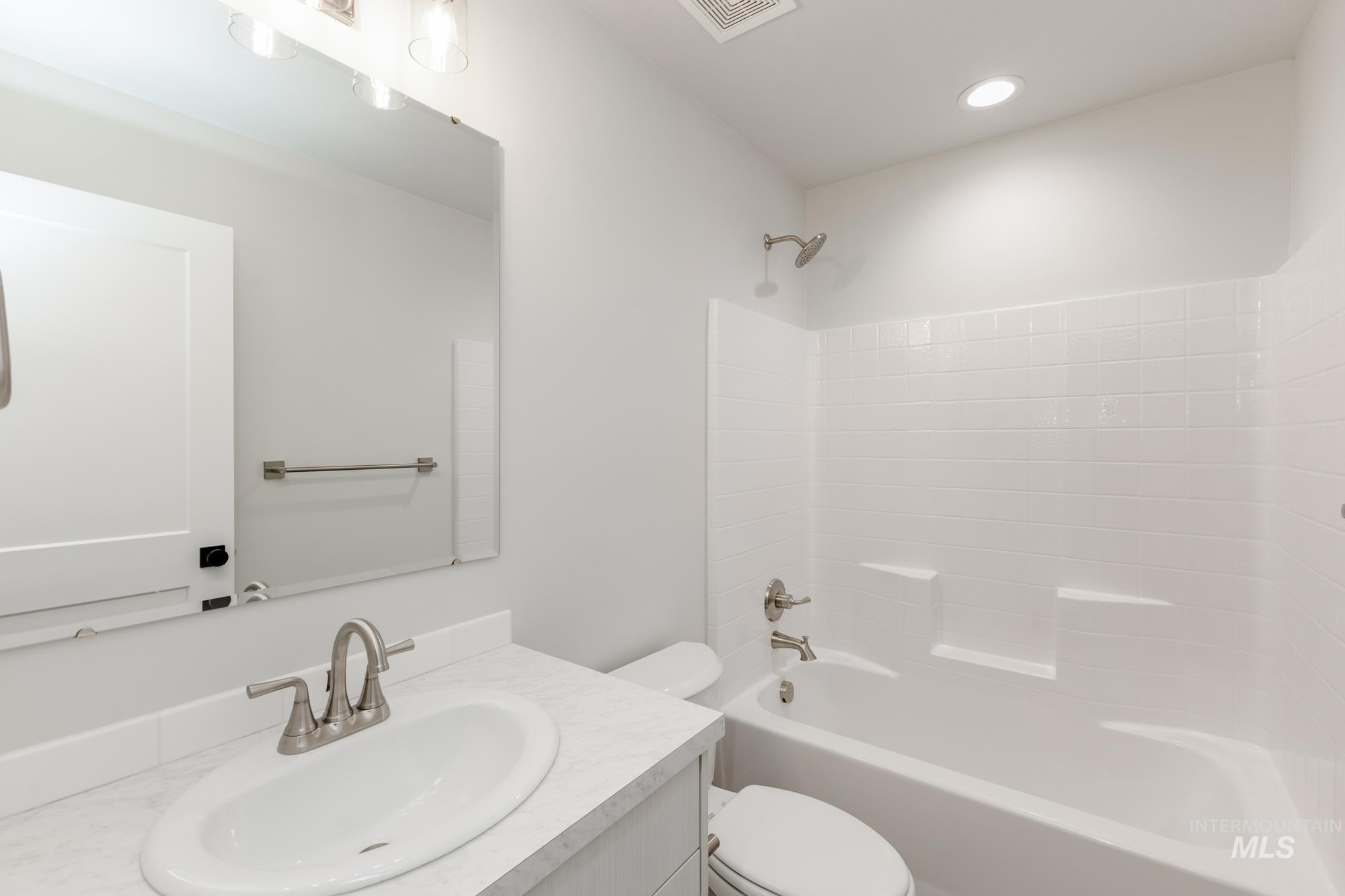 Full bath with shower / bathtub combination, vanity, and recessed lighting